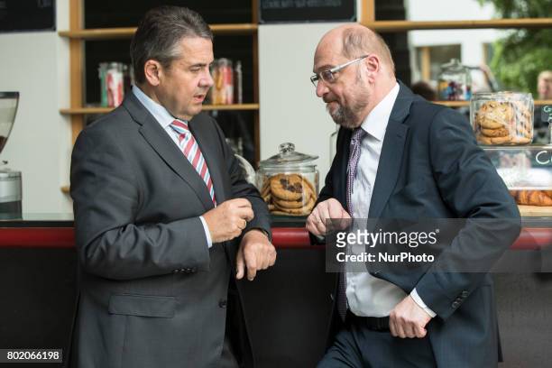 Chancellor Candidate and chairman of the Social Democratic Party Martin Schulz chats with foreign minister Sigmar Gabriel after a news conference to...