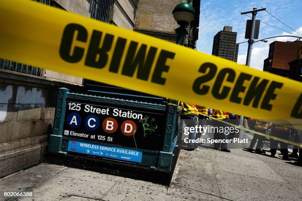 Crime scene tape is placed outside of a Metropolitan Transportation Authority Harlem subway station where a morning train derailment occurred on June...