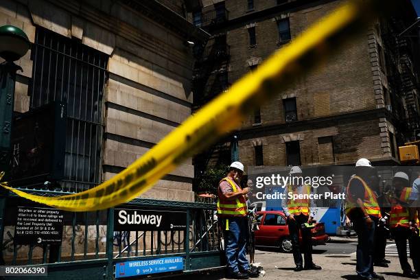 Crime scene tape is placed outside of a Metropolitan Transportation Authority Harlem subway station where a morning train derailment occurred on June...