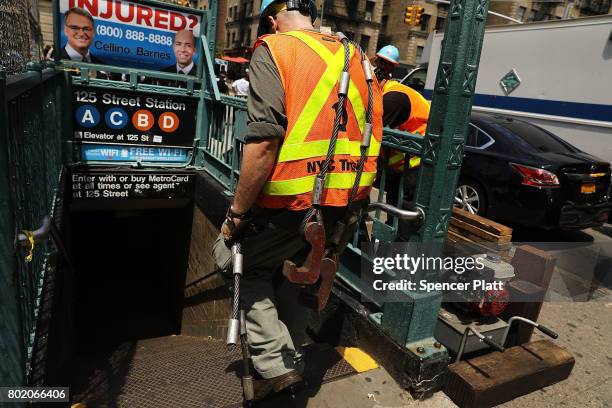 Metropolitan Transportation Authority worker enters a Harlem subway station where a morning train derailment occurred on June 27, 2017 in New York...