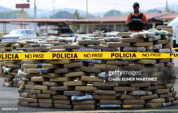 Panamanian National Police member guards cocaine packages in Panama City on March 11 after a 1,572 kg cargo seizure in the Pacific Ocean last Sunday....