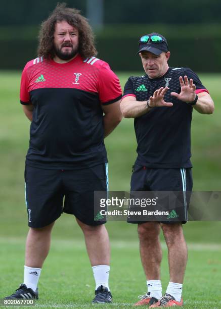 The Harlequins Head coach Mark Mapletoft chats with Adam Jones during a Harlequins pre-season training session at Surrey Sports Park on June 27, 2017...
