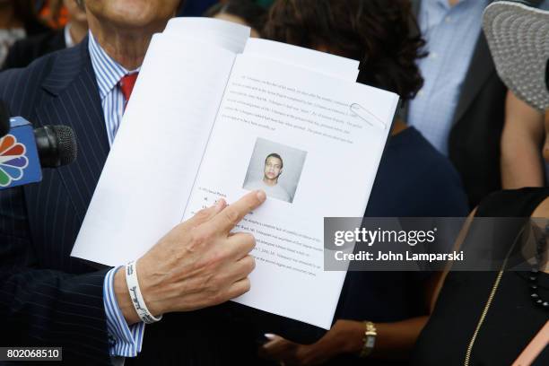 Attorney Robert C. Gottlieb shows Jon Adrian Velazquez's arrest photo during a press conference for retrial motion filed for Jon Adrian Velazquez on...