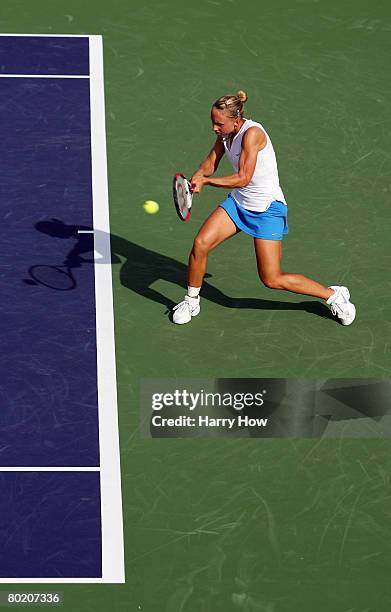 Julia Schruff of Germany returns a backhand in her match against Tatiana Poutchek of Belarus during qualifications for the Pacific Life Open at the...