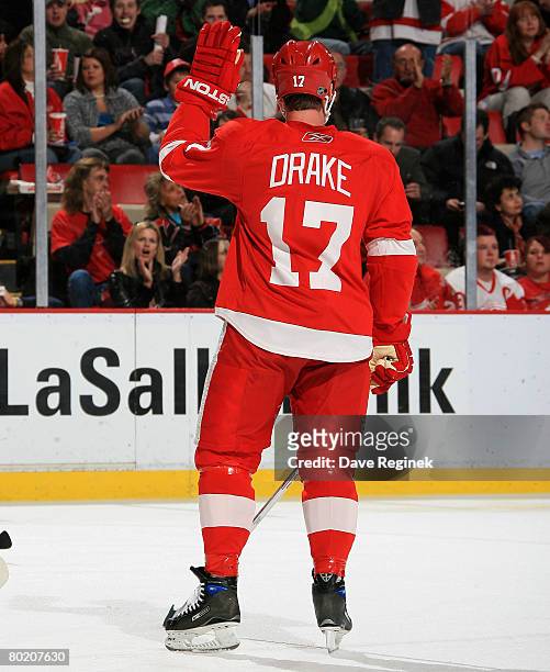 Dallas Drake of the Detroit Red Wings waves to the crowd in acknowlegement of his 1,000th NHL played game against the Chicago Blackhawks on March 11,...