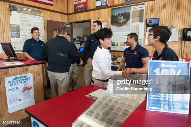 Maggie Hardy Magerko, president and owner of 84 Lumber Co., center, greets a worker at the company's retail store in Bridgeville, Pennsylvania, U.S.,...