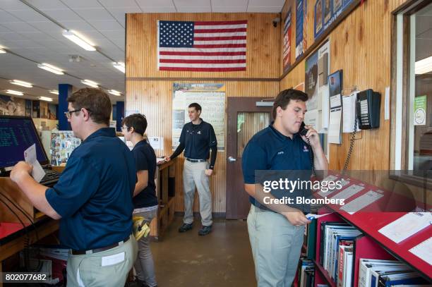Workers stand behind the check out counter at the 84 Lumber Co. Retail store in Bridgeville, Pennsylvania, U.S., on Thursday, June 8, 2017. One of...