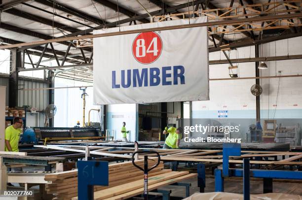 Workers assemble roof trusses at the 84 Lumber Co. California Truss Plant in Coal Center, Pennsylvania, U.S., on Friday, June 9, 2017. One of the...