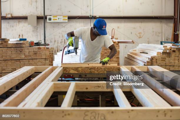 Worker assembles wall panels at the 84 Lumber Co. California Truss Plant in Coal Center, Pennsylvania, U.S., on Friday, June 9, 2017. One of the...