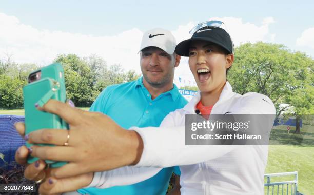 Michelle Wie takes a selfie photo with former NFL player Brian Urlacher during the pro-am prior to the start of the 2017 KPMG Women's PGA...