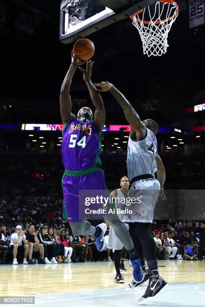 Kwame Brown of the 3 Headed Monsters drives to the basket against Ivan Johnson of the Ghost Ballers during week one of the BIG3 three on three...