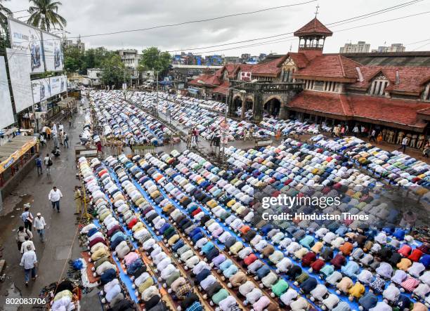 Muslims offer Eid al-Fitr prayers at outside Bandra station on June 26, 2017 in Mumbai, India. Eid al-Fitr marks the end of the Muslims' holy fasting...