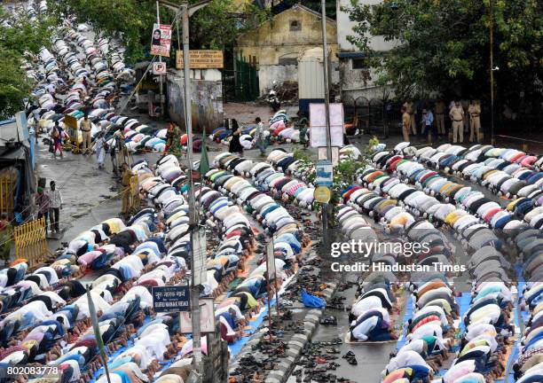 Muslims offer Eid al-Fitr prayers at outside Bandra station on June 26, 2017 in Mumbai, India. Eid al-Fitr marks the end of the Muslims' holy fasting...