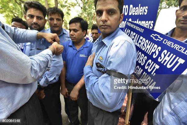 General Motors India’s dealers, members of Federation of Automobiles dealers Associations along with their employees protest against Chevrolet after...