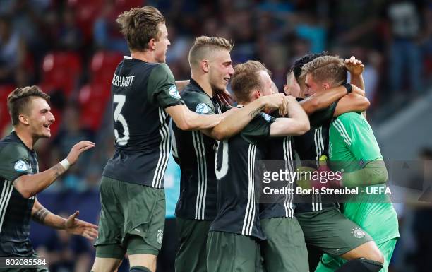 Jannik Pollersbeck of Germany celebrates with his team mates after he saved a penalty from Nathan Redmond of England to win his side the penalty...