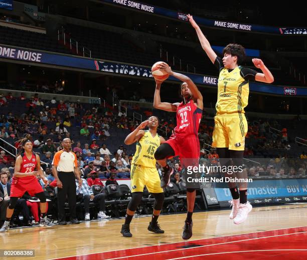 Shatori Walker-Kimbrough of the Washington Mystics goes for a lay up against Ramu Tokashiki of the Seattle Storm on June 27, 2017 at the Verizon...