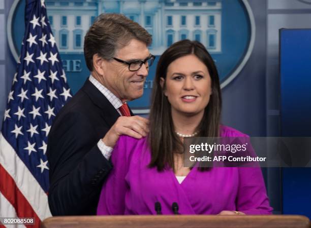 Energy Secretary Rick Perry arrives to take the podium from Principal Deputy White House Press Secretary Sarah Huckabee Sanders at the press briefing...