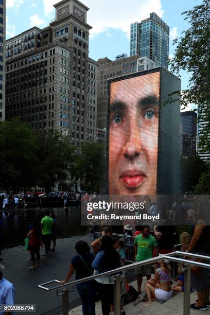 Chicagoans enjoy a warm summer afternoon at Jaume Plensa's 'Crown Fountain' sculpture in Millennium Park in Chicago, Illinois on June 24, 2017.