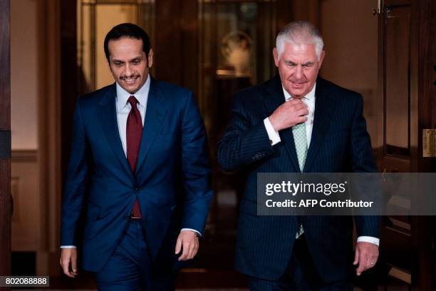 Qatars Foreign Minister Mohammed bin Abdulrahman al-Thani and US Secretary of State Rex Tillerson walk together before a meeting at the US State...