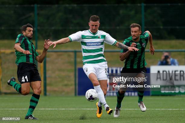 Scott Quigley of The New Saints competes with Alberto Sanchez and Martin Belfortti of Europa FC during the Champions League Qualifier between The New...