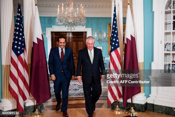 Qatars Foreign Minister Mohammed bin Abdulrahman al-Thani and US Secretary of State Rex Tillerson walk together before a meeting at the US State...