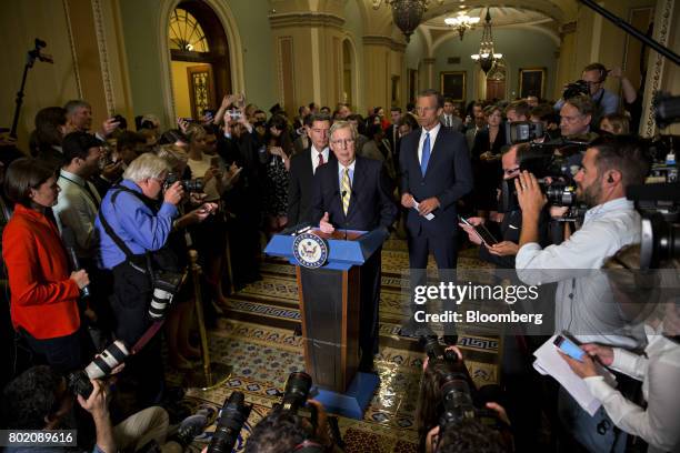 Senate Majority Leader Mitch McConnell, a Republican from Kentucky, center, speaks during a news conference after a GOP luncheon meeting at the U.S....