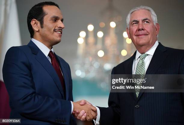 Secretary of State Rex Tillerson shakes hands with Qatari Foreign Minister Sheikh Mohammed Bin Abdulrahman Al Thani prior to a scheduled meeting at...