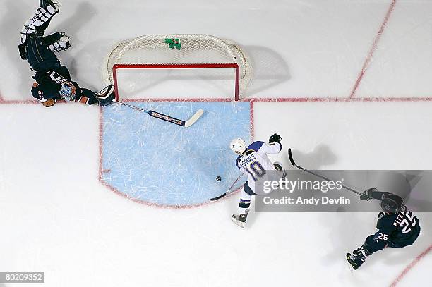 Andy McDonald of the St. Louis Blues puts the puck into an open net after an unlucky bounce off the glass against Mathieu Garon of the Edmonton...