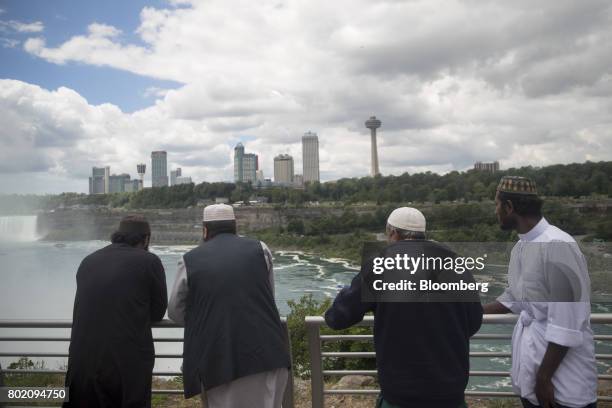 Tourists view the Horseshoe Falls in Niagara Falls, New York, U.S., on Wednesday, June 21, 2017. The 150th anniversary of Canada, promoted as Canada...