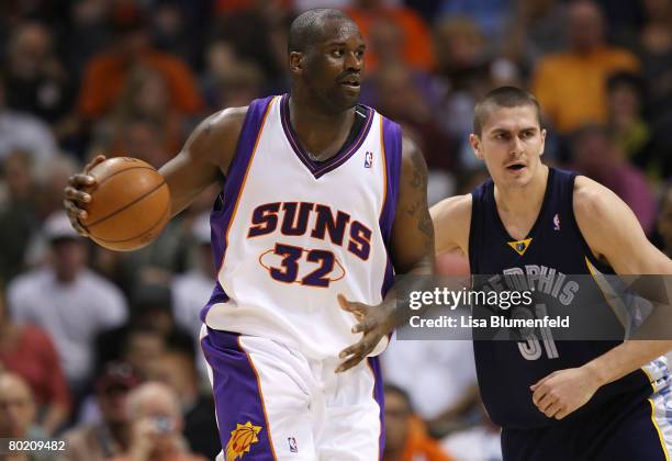 Shaquille O'Neal of the Phoenix Suns drives against Darko Milicic of the Memphis Grizzlies at US Airways Center on March 11, 2008 in Phoenix,...