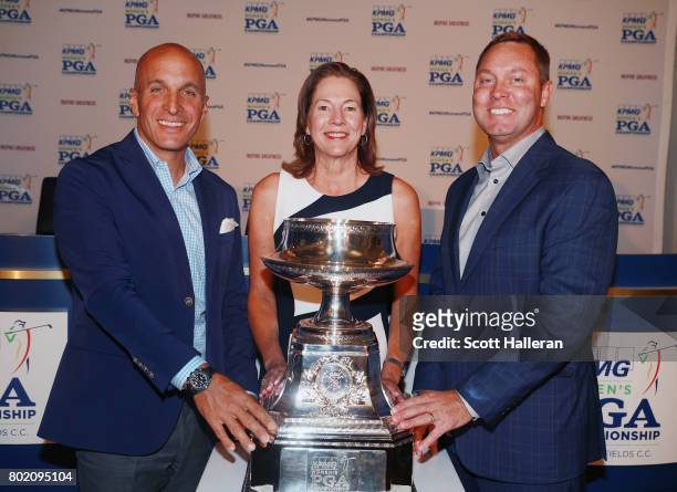 Pete Bevacqua, CEO of the Pga of America, Lynne Doughtie, Chairman and CEO of KPMG and LPGA Commissioner Mike Whan pose together after an announcment...
