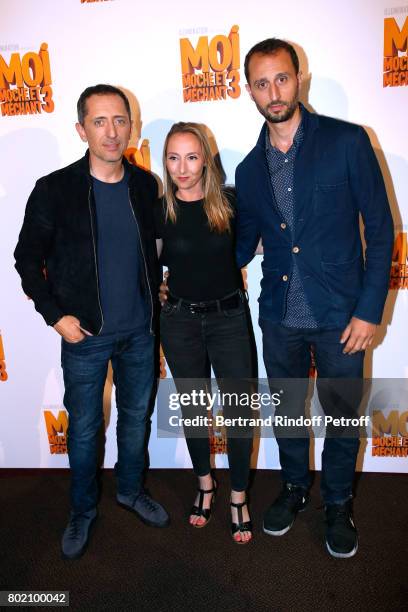 Voices of the movie, Audrey Lamy standing between Gad Elmaleh and his brother Arie Elmaleh attend the Despicable Me Paris Premiere at Cinema Gaumont...