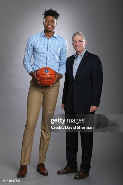 Justin Patton of the Minnesota Timberwolves poses for a portrait with GM Scott Layden on June 27, 2017 at the Minnesota Timberwolves and Lynx Courts...