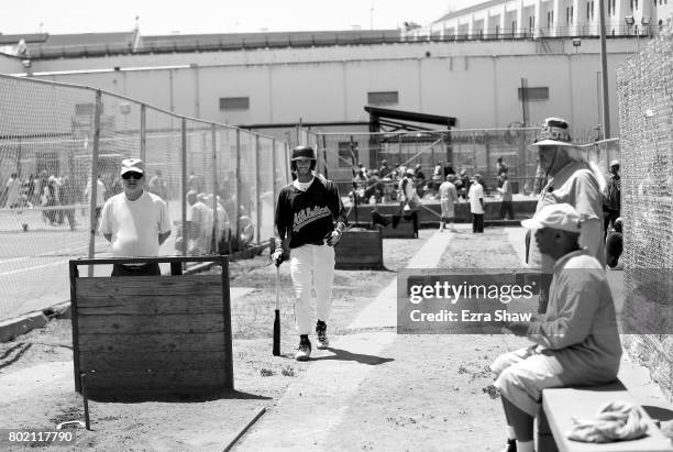 Branden Terrel walks through the yard on his way to returning to their baseball game against the Sonoma Stompers on May 27, 2017 in San Quentin,...