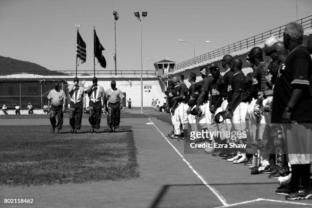 Inmates present the flags before the San Quentin Athletics game against Club Mexico on April 29, 2017 in San Quentin, California. Branden Terrel was...
