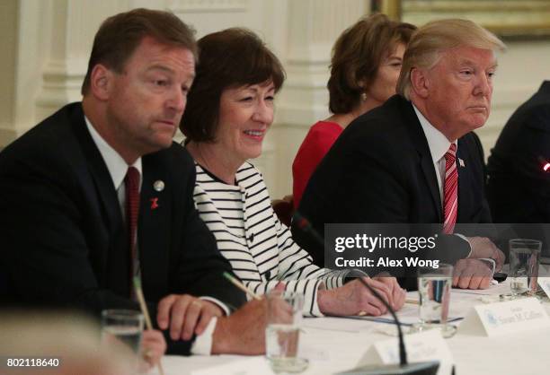 President Donald Trump speaks as Sen. Dean Heller and Sen. Susan Collins listen during a meeting with Senate Republicans at the East Room of the...