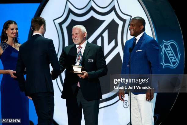 Former NHL players Bernie Parent, left, and Kevin Weekes greet Sergei Bobrovsky of the Columbus Blue Jackets onstage after Bobrovsky won the Vezina...