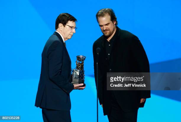 Host David Harbour presents David Poile with the NHL General Manager of the Year Award onstage during the 2017 NHL Awards & Expansion Draft at...