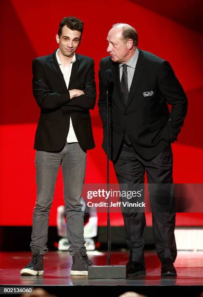 Presenters Jay Baruchel and former NHL player Bob Gainey speak onstage to announce the winner of the Frank J. Selke Trophy during the 2017 NHL Awards...