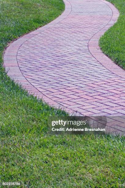 winding brick pathway in the grass - brick pathway stock pictures, royalty-free photos & images