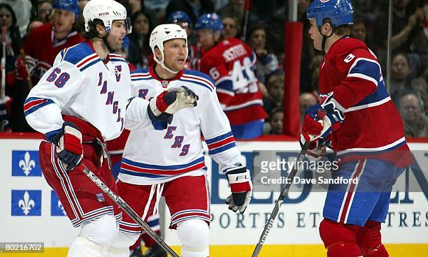 Mike Komisarek of the Montreal Canadiens taunts Sean Avery and Jaromir Jagr both of the New York Rangers during their NHL game at the Bell Centre...