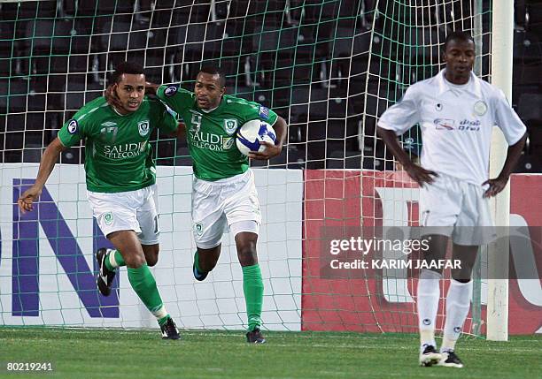 Saudi Al-Ahli club players Osvaldo Baiano and Malek Muaz celebrate after scoring a goal as Mohammed Rabih of Qatari Al-Sadd club looks on during...