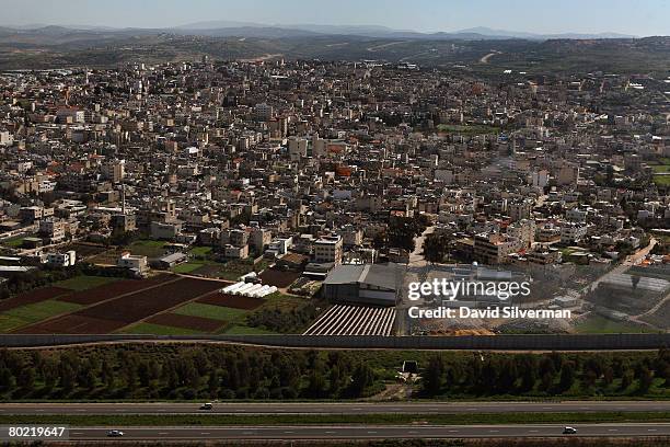 An aerial view of Israel's separation barrier as it encloses the Palestinian town of Qalqilya March 12, 2008 alongside Israel's Route 6 highway. The...