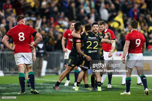 Wes Goosen of the Hurricanes celebrates his try with Vince Aso and Nehe Milner-Skudder during the match between the Hurricanes and the British &...