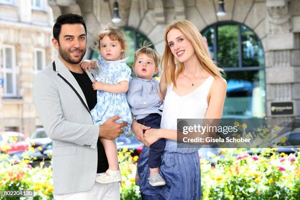 Wilma Elles poses with her husband Kerem Goegus and their twins, son Milat and daughter Melodi during a photo session on June 27, 2017 in Munich,...