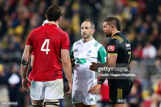 Referee Romain Poite of France talks to Iain Henderson of the Lions before showing his a yellow card during the match between the Hurricanes and the...