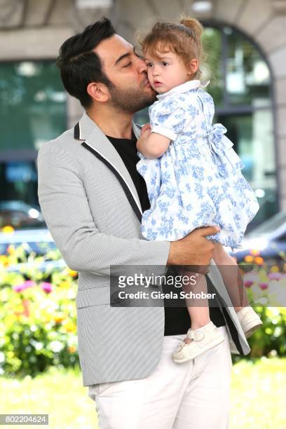Kerem Goegus, Wilma Elles husband, poses with his daughter Melodi during a photo session on June 27, 2017 in Munich, Germany.