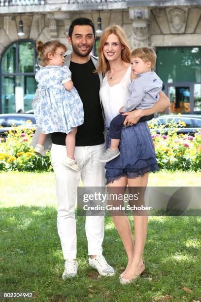 Wilma Elles poses with her husband Kerem Goegus and their twins, son Milat and daughter Melodi during a photo session on June 27, 2017 in Munich,...