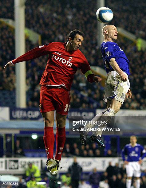 Everton's English forward Andrew Johnson wins a header from Fiorentina's Italian defender Dario Dainelli during the UEFA Cup Fourth Round Second Leg...