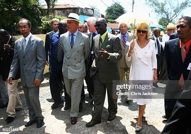 Camilla, Duchess of Cornwall and Prince Charles, The Prince of Wales walk through Rose Town on the first day of a three day tour of Jamaica on March...
